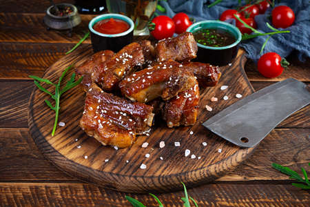 Grilled sliced ribs in sweet and sour sauce. Ribs marinated in honey sauce with herbsの写真素材