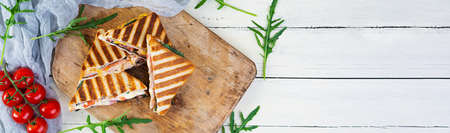 Sandwich with ham, cheese, mustard leaves, tomatoes and onion. Tasty grilled sandwiches