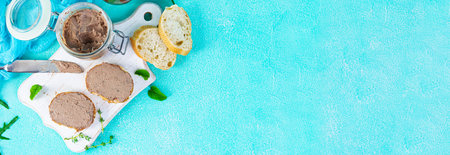 Sandwich with chicken liver pate on blue background. top view