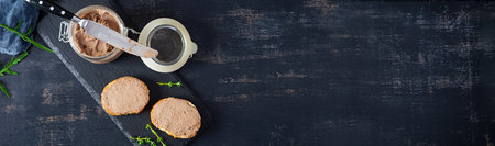 Sandwich with chicken liver pate on dark background. top view
