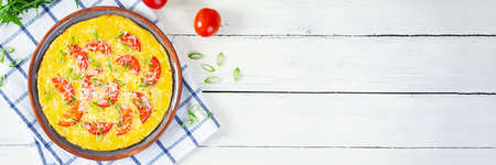 Omelette with tomatoes, herbs and grated cheese. Easy breakfastの写真素材