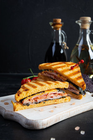 Club sandwich with ham, tomato and cheese. Grilled sandwichの写真素材