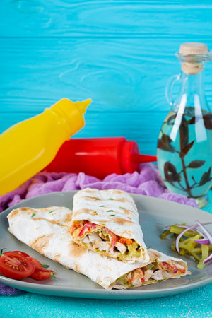 Delicious grilled chicken shawarma sandwich. Wraped in lavash doner kebab