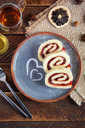 Swiss roll with strawberry jam. Jelly roll with decorationの写真素材
