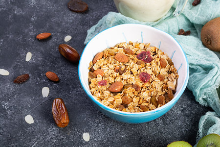 Bowl of granola with nuts, berries and yogurt. Muesli oats with fruitsの写真素材