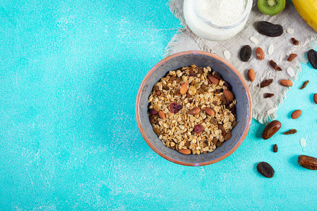 Bowl of granola with nuts, berries and yogurt. Muesli oats with fruitsの写真素材