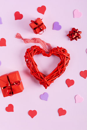 Valentine's Day background. Decorations heart shaped confetti, gift boxes in wrapping paperの写真素材