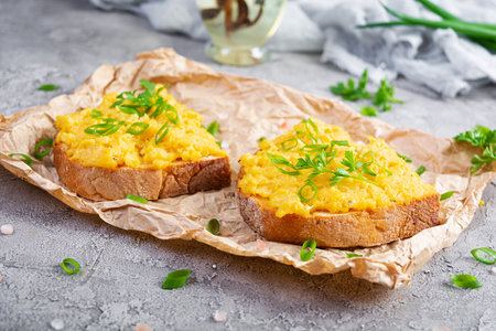 Scrambled eggs with herbs and toasts. Delicious breakfast with eggs and herbsの写真素材