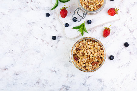 Granola with yogurt and fresh berries. Healthy breakfast of oat muesliの写真素材