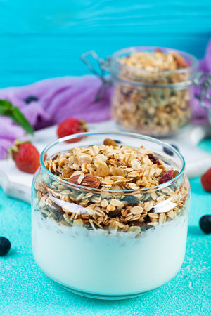 Granola with yogurt and fresh berries. Healthy breakfast of oat muesliの写真素材