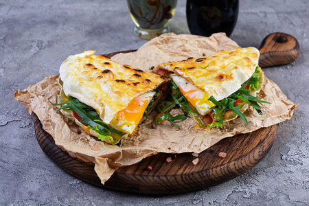 Grilled stuffed lavash with herbs, tomato and egg. Lavash sandwich