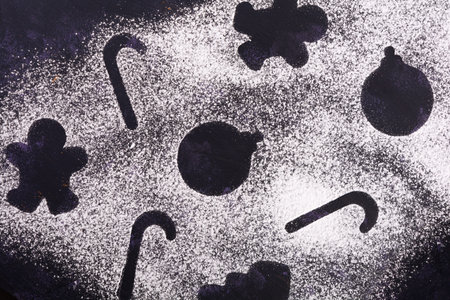 Christmas or New Year's background is made of drawings with powdered sugarの写真素材