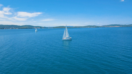 Aerial view of yacht sailing near beautiful Islands. Beautiful clouds in the background. Luxury...