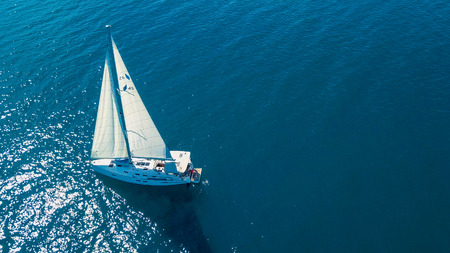 Aerial view of yacht sailing near beautiful Islands. Beautiful clouds in the background. Luxury...