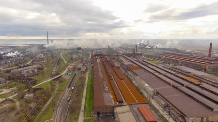 Aerial view of industrial steel plant. Aerial sleel factory. Flying over smoke steel plant pipes....
