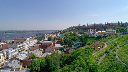 City view with a river in the background. The buildings are old and the trees are green.の写真素材