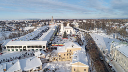 Snowy city with a large crowd of people walking around. The ancient Russian city of Suzdalの写真素材