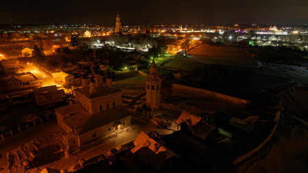 City at night with a church in the middle. The sky is dark and the buildings are lit up.の写真素材