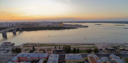 City skyline with a large body of water in the background. The sky is orange and the water is calm.