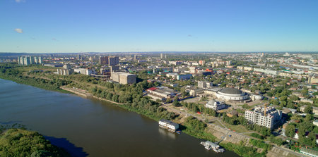 City with a river running through it. The river is full of boats and the city is full of buildings....