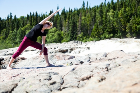 Yoga in nature with a young girlの写真素材