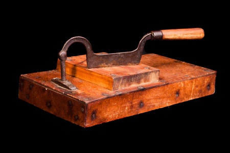 Antique tobacco leaves chopper isolated on blackの写真素材