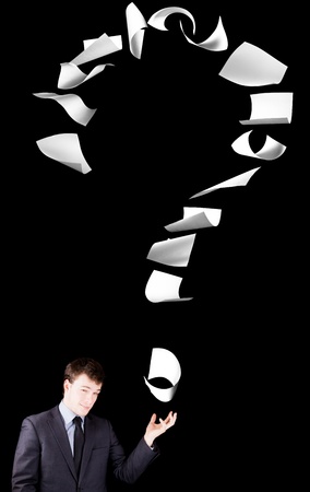 Businessman showing a question mark made of floating papers.の写真素材