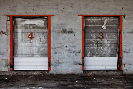 Old Grungy Industrial Dock Doors with Graffitis. Dirty and Abandoned Placeの写真素材