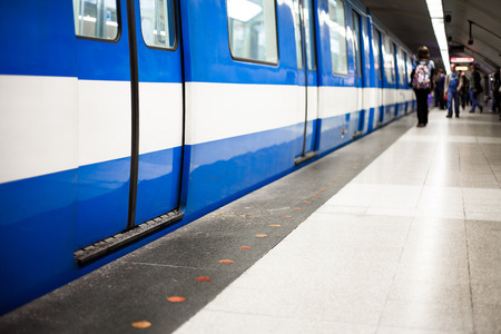 Colorful Underground Subway Train with blurry People on the Platform. Focus is on the door. room for your text.のeditorial素材