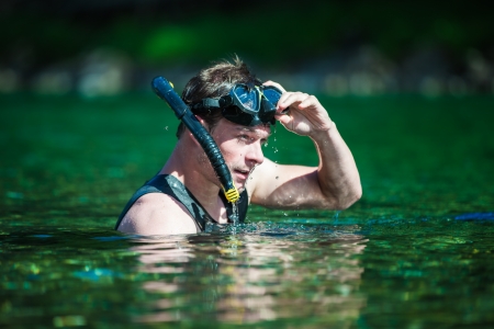 Young Adult Snorkeling in a river with Goggles and Scuba.の写真素材