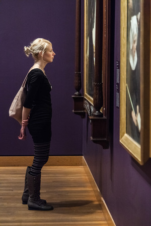 Editorial - Montreal, Canada - Montreal Fine Arts Museum Room with Paintings on the wall and Young Adult looking at it.のeditorial素材