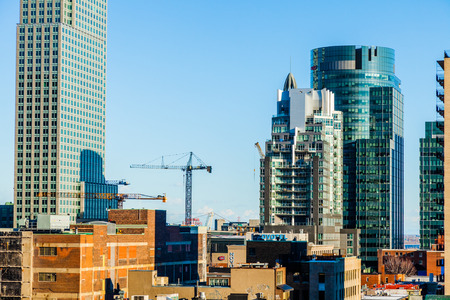 Editorial - Montreal, Canada. Scene of the City during the End of a Winter Day while you can see a bit of Construction and Cranes. Molson center and CH logo is visible like the Farine Five Roses Old Company.のeditorial素材