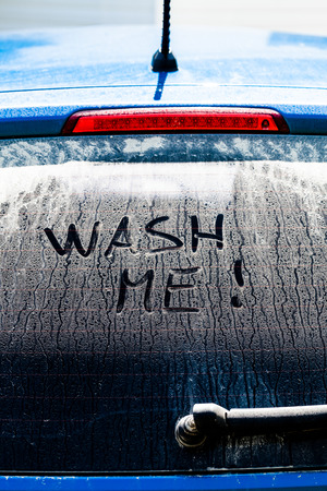 Wash Me Words on a Dirty Rear Car Windowの写真素材