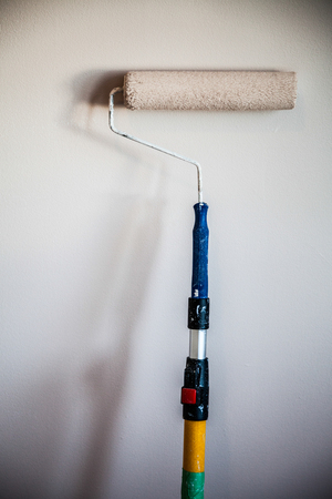 Closeup of a Paint Roller on the Wallの写真素材