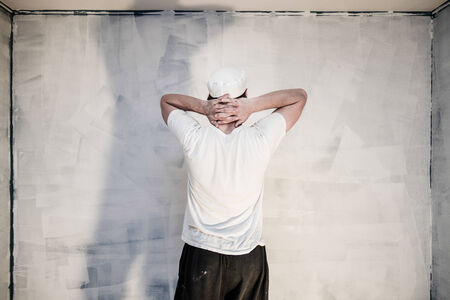 Pensive Men Looking at the Painted Wallの写真素材