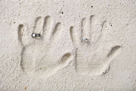 Destination Wedding Concept Using Two Hand Pints of a Couple and Wedding Bandsの写真素材