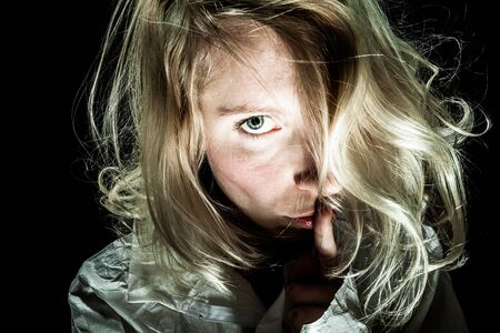 Psycho Woman asking for Silence with Finger on Lipsの写真素材