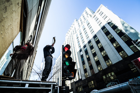 MONTREAL, CANADA, APRIL 02 2015. Riot in the Montreal Streets to counter the Economic Austerity Measures. Protesters With Horn on top of Structure Plays a War Cry.のeditorial素材