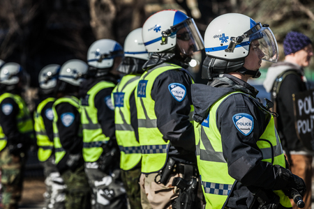 MONTREAL, CANADA, APRIL 02 2015. Riot in the Montreal Streets to counter the Economic Austerity Measures. Closeup of Police Gear and Protectionsのeditorial素材