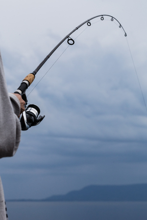 Detail of a Fishing Rod and Colorful Sky