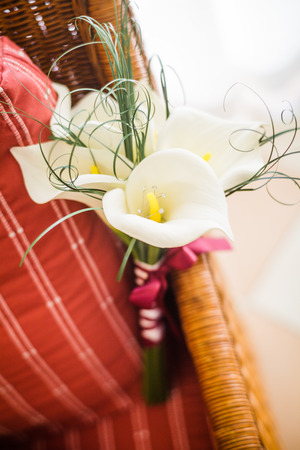 Wedding Lily Flowers Bouquet on a Red Chairの写真素材