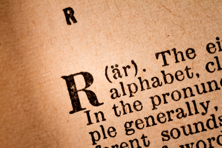 October 1st, 2015 - Montreal, Canada. Close-up of a R, the 18th Letter of the Latin Alphabet into a Old Pronunciation Dictionary October 1st, 2015 - Montreal, Canada. Close-up of a R, the 18th Letter of the Latin Alphabet into a Old Pronunciation Dictionary