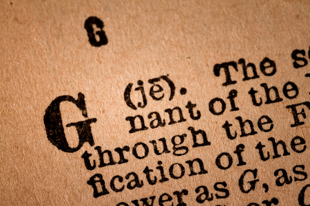 October 1st, 2015 - Montreal, Canada. Close-up of a G, the 7th Letter of the Latin Alphabet into a Old Pronunciation Dictionary October 1st, 2015 - Montreal, Canada. Close-up of a G, the 7th Letter of the Latin Alphabet into a Old Pronunciation Dictionary