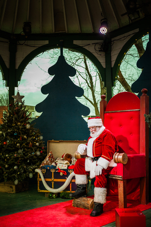 Longueuil, CANADA - December 22nd 2015. Christmas Market Taking Place in a Park. More than Fifty Vendors Present. Man doing the Santa Claus and Waiting for the Next Kid to come.のeditorial素材