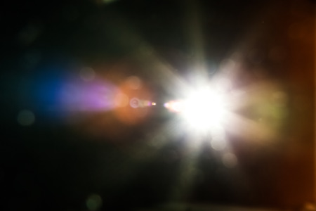 Real Lens Flare Shot in Studio over Black Background. Easy to add as Overlay or Screen Filter over Photosの写真素材