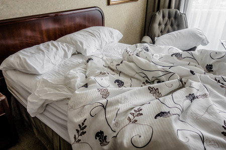 Messy Bed on the Morning in a Hotel