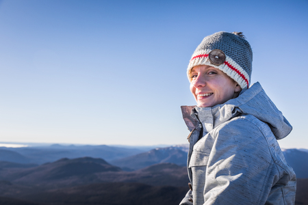 Happy Woman Enjoying the View of the Richardson Mountain's Summit in Gaspe, Quebec, Canada.の写真素材
