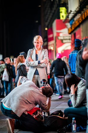 NEW YORK, USA - October 14, 2016. Photoshoot in the Middle of Times Square of a Woman and Buildings in Background, 'anhattan, New York.のeditorial素材