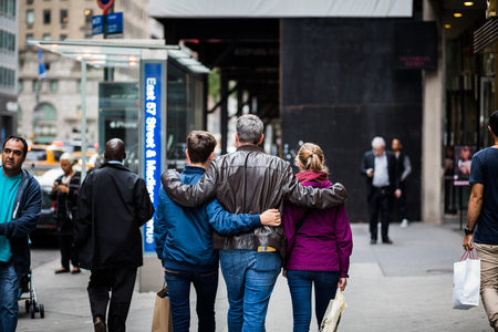 NEW YORK, USA - October 13, 2016. Father and two kids walking together on the 5th Avenue in New York Cityのeditorial素材