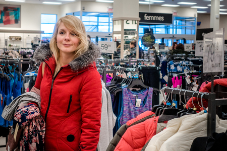RIMOUSKI, CANADA - February 19, 2017. Woman Looking for Deals in a Winners Store in Rimouski, Quebec.のeditorial素材